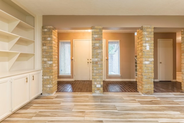 518 Lorie Ln, Pasadena, TX 77586 - foyer featuring ornate columns and light wood-style flooring