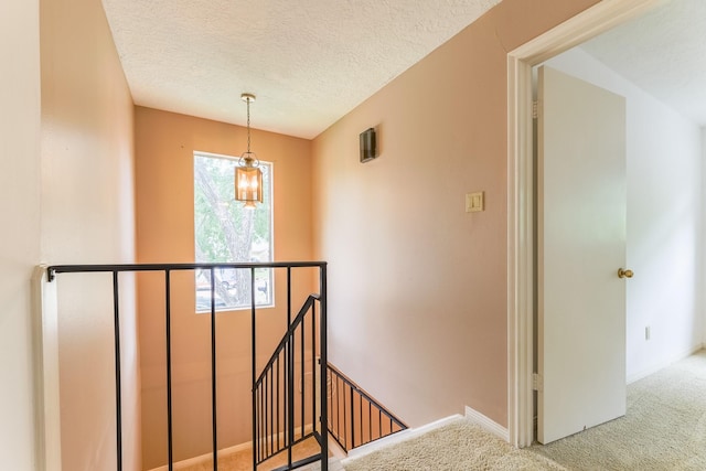 518 Lorie Ln, Pasadena, TX 77586 - stairs featuring carpet, a textured ceiling, and baseboards