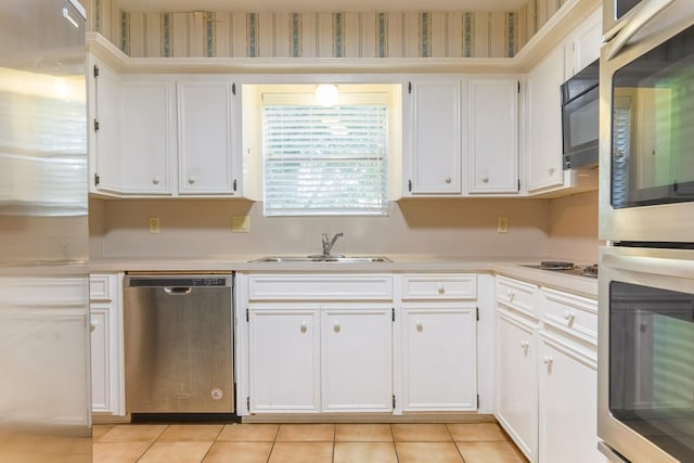 518 Lorie Ln, Pasadena, TX 77586 - kitchen with stainless steel appliances, a sink, light countertops, and white cabinets