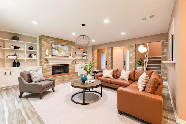 518 Lorie Ln, Pasadena, TX 77586 - living area featuring a fireplace, light wood-style flooring, stairs, recessed lighting, and built in features