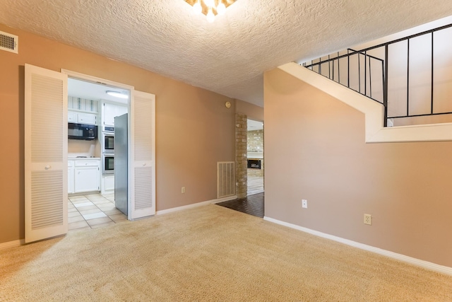 518 Lorie Ln, Pasadena, TX 77586 - empty room with light colored carpet, baseboards, and a textured ceiling