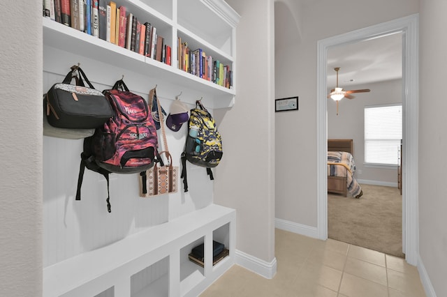 9103 Lacombe Ln, Tomball, TX 77375 - mudroom with a ceiling fan, baseboards, tile patterned floors, and carpet