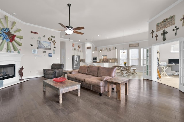 9103 Lacombe Ln, Tomball, TX 77375 - living area featuring ceiling fan, dark wood-type flooring, baseboards, a glass covered fireplace, and ornamental molding