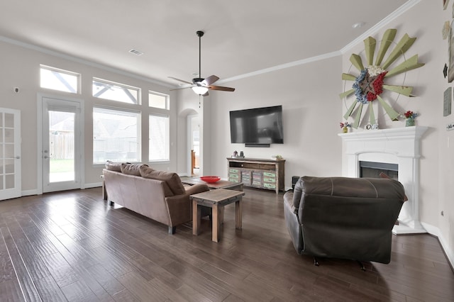9103 Lacombe Ln, Tomball, TX 77375 - living room with crown molding, plenty of natural light, dark wood-style floors, a fireplace, and baseboards