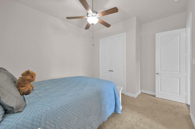 9103 Lacombe Ln, Tomball, TX 77375 - bedroom with light carpet, baseboards, a closet, and a ceiling fan