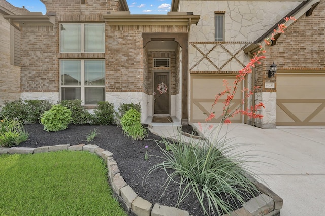 9103 Lacombe Ln, Tomball, TX 77375 - entrance to property featuring concrete driveway, an attached garage, brick siding, and stone siding