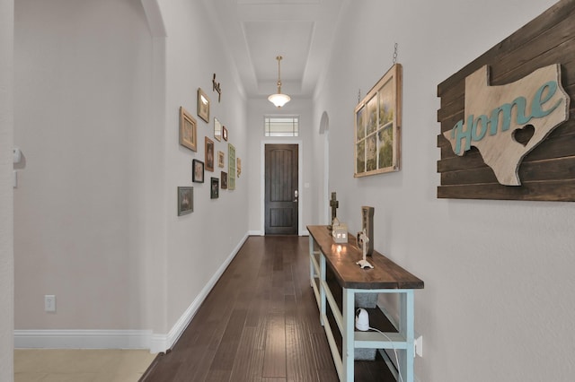 9103 Lacombe Ln, Tomball, TX 77375 - doorway with arched walkways, baseboards, and dark wood-style floors