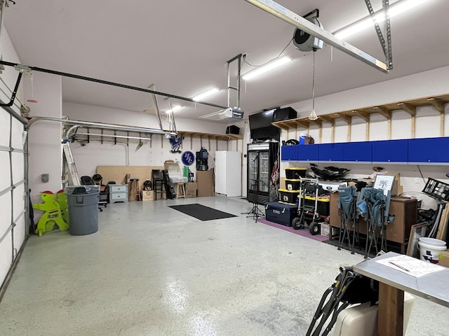 9103 Lacombe Ln, Tomball, TX 77375 - garage with freestanding refrigerator and a garage door opener