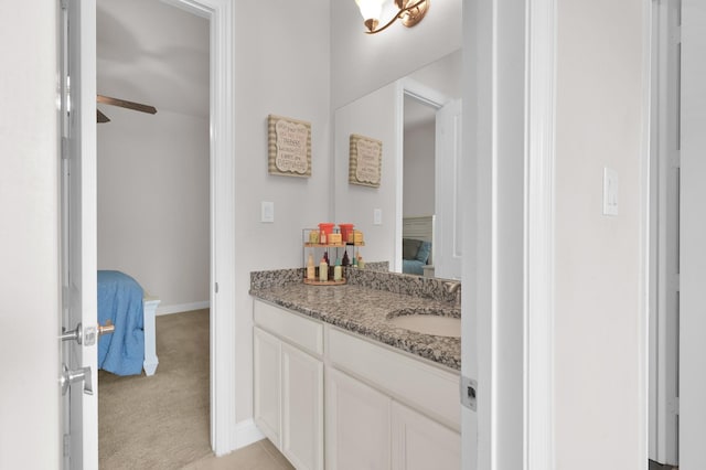 9103 Lacombe Ln, Tomball, TX 77375 - ensuite bathroom with vanity, ceiling fan, and baseboards