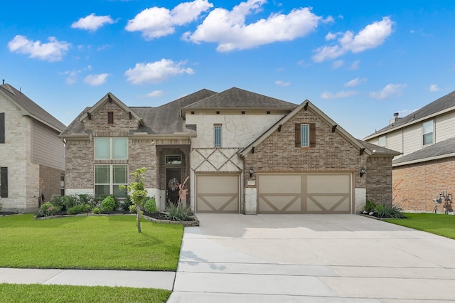 9103 Lacombe Ln, Tomball, TX 77375 - view of front of home with concrete driveway, brick siding, a front lawn, and roof with shingles