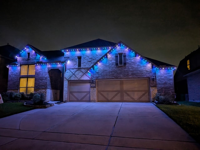 9103 Lacombe Ln, Tomball, TX 77375 - view of front of property with stone siding, a garage, and concrete driveway