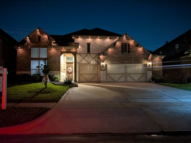 9103 Lacombe Ln, Tomball, TX 77375 - view of front facade featuring concrete driveway, stone siding, a lawn, and a garage