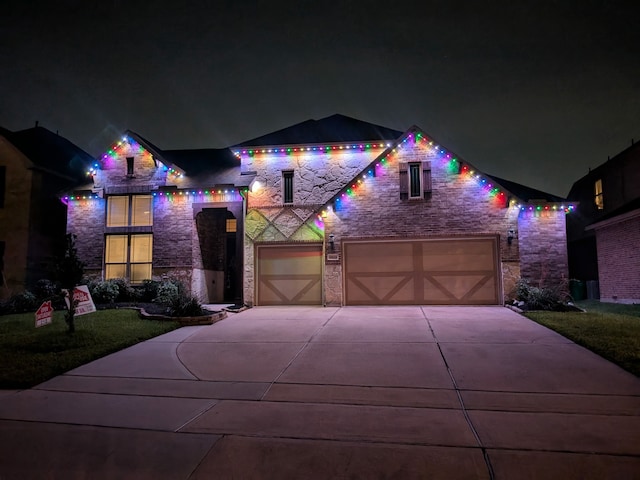 9103 Lacombe Ln, Tomball, TX 77375 - view of front of property featuring stone siding and concrete driveway