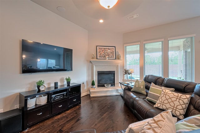 10147 Deerpark Dr, Missouri City, TX 77459 - living area featuring dark wood-type flooring, a glass covered fireplace, baseboards, and recessed lighting