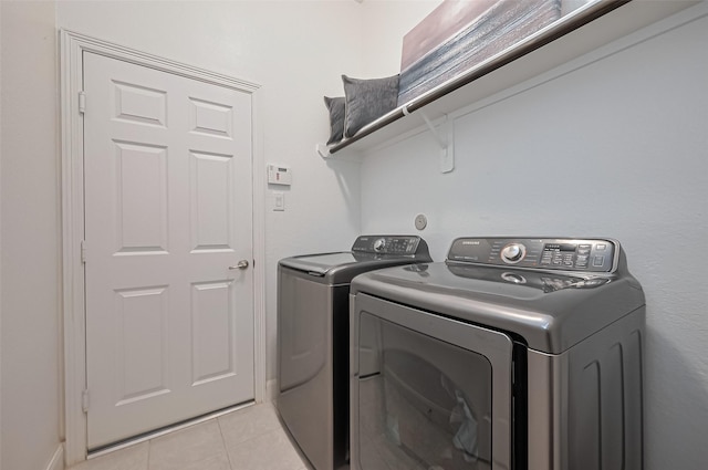 10147 Deerpark Dr, Missouri City, TX 77459 - laundry room featuring washing machine and clothes dryer and light tile patterned floors