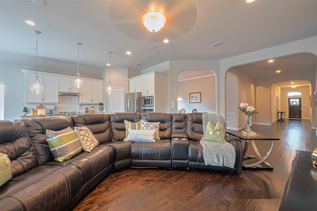 10147 Deerpark Dr, Missouri City, TX 77459 - living room featuring arched walkways, dark wood-type flooring, and recessed lighting