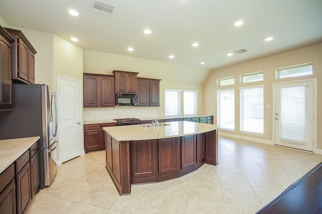 14110 Green Thicket Dr, Pearland, TX 77584 - kitchen featuring appliances with stainless steel finishes, a sink, a center island with sink, decorative backsplash, and recessed lighting
