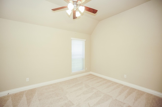 14110 Green Thicket Dr, Pearland, TX 77584 - spare room with baseboards, vaulted ceiling, a ceiling fan, and light colored carpet