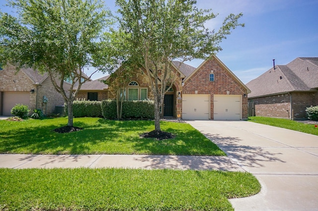 14110 Green Thicket Dr, Pearland, TX 77584 - view of front of house with driveway, brick siding, a front lawn, and an attached garage