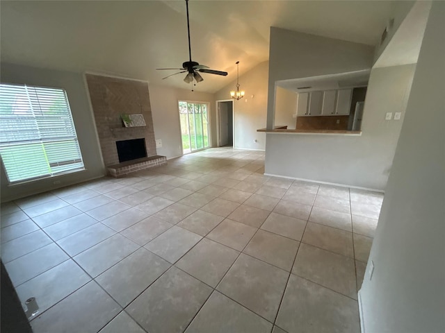 4111 Fitzwater Dr, Spring, TX 77373 - unfurnished living room with light tile patterned floors, ceiling fan, a chandelier, high vaulted ceiling, and a large fireplace