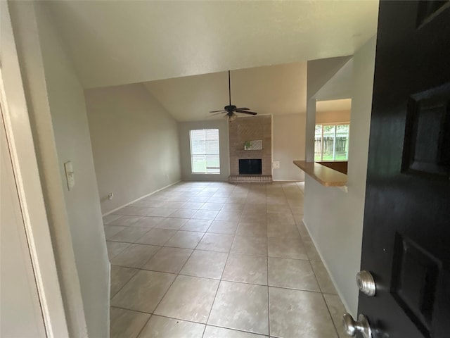 4111 Fitzwater Dr, Spring, TX 77373 - unfurnished living room featuring light tile patterned floors, a ceiling fan, baseboards, a brick fireplace, and high vaulted ceiling