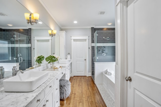 823 E 27th St, Houston, TX 77009 - bathroom with crown molding, double vanity, a stall shower, wood finished floors, and a chandelier