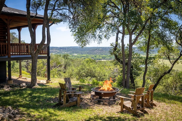 1012 Mourning Dove, Canyon Lake, TX 78133 - view of grassy yard with an outdoor fire pit and a wooden deck