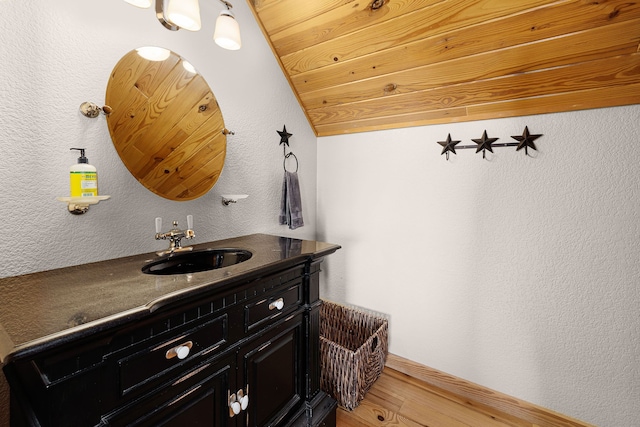 1012 Mourning Dove, Canyon Lake, TX 78133 - bathroom with wood finished floors, vanity, a textured wall, and baseboards