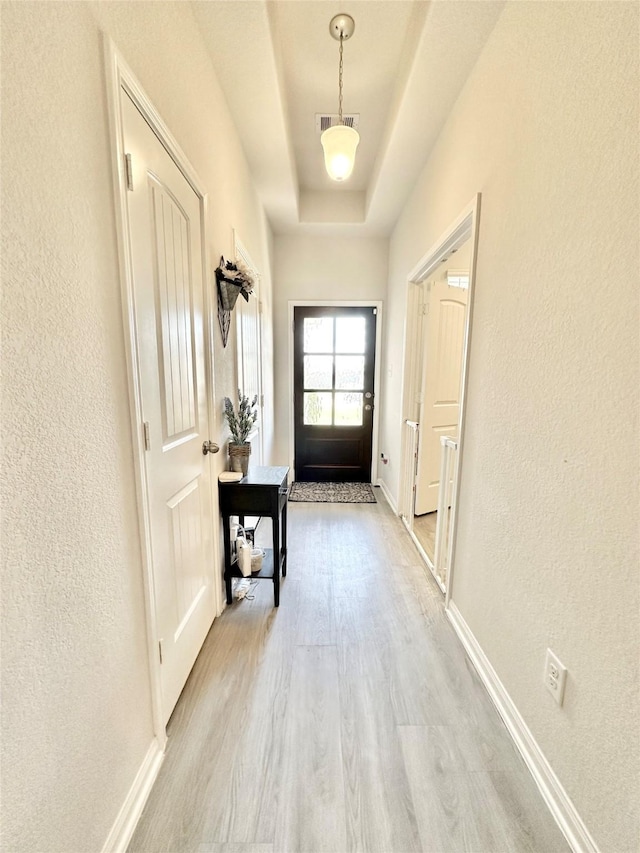 1410 Alice, Beaumont, TX 77705 - entryway with light wood-type flooring, a textured wall, baseboards, and a raised ceiling