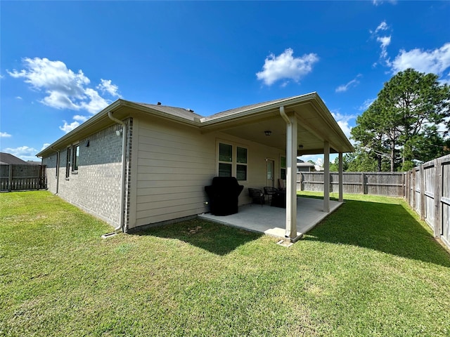 1410 Alice, Beaumont, TX 77705 - rear view of house featuring a patio and brick siding