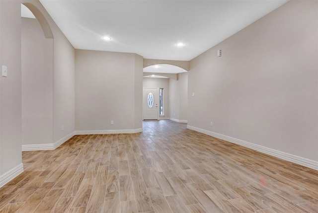 1805 Rollingwood Dr, Huntsville, TX 77340 - empty room with arched walkways, light wood-type flooring, baseboards, and recessed lighting