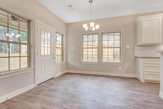 1805 Rollingwood Dr, Huntsville, TX 77340 - unfurnished dining area featuring a chandelier, light wood-style floors, and baseboards