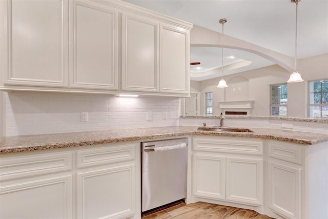 1805 Rollingwood Dr, Huntsville, TX 77340 - kitchen featuring dishwasher, a sink, arched walkways, decorative backsplash, and white cabinets