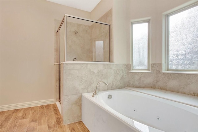 1805 Rollingwood Dr, Huntsville, TX 77340 - full bath with a stall shower, a tub with jets, and wood finished floors
