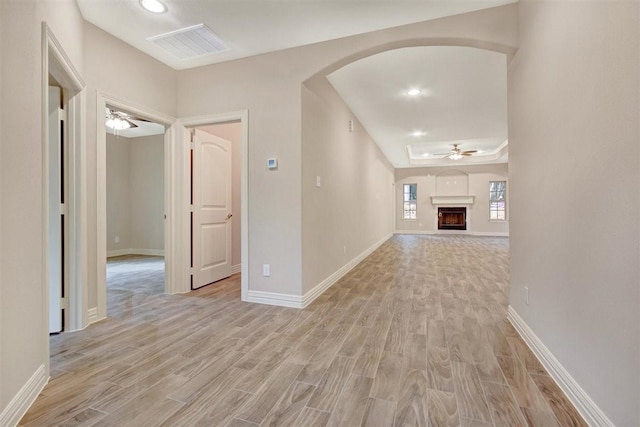 1805 Rollingwood Dr, Huntsville, TX 77340 - corridor featuring light wood-style flooring, arched walkways, baseboards, and recessed lighting