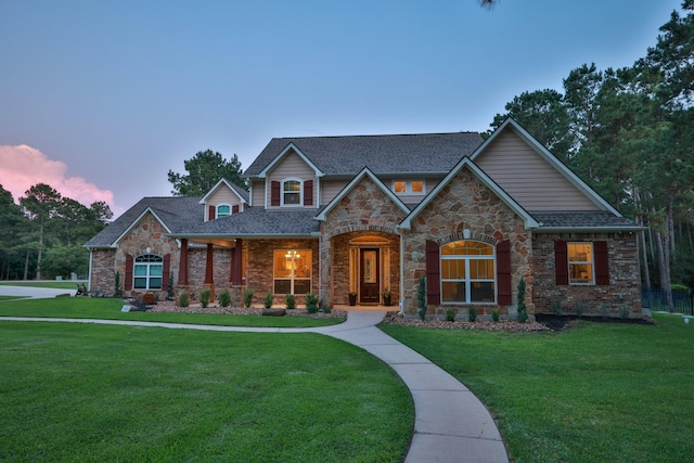 29122 Champions Dr, Magnolia, TX 77355 - craftsman inspired home with a lawn, a shingled roof, and brick siding