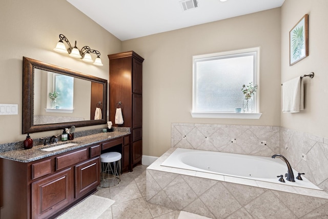 29122 Champions Dr, Magnolia, TX 77355 - bathroom with vanity, a jetted tub, and tile patterned flooring