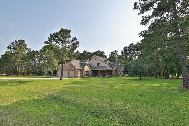 29122 Champions Dr, Magnolia, TX 77355 - traditional-style home with a garage, driveway, a front yard, and stone siding