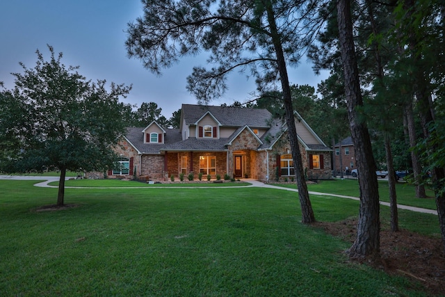 29122 Champions Dr, Magnolia, TX 77355 - view of front of house featuring a front lawn, a porch, stone siding, and brick siding