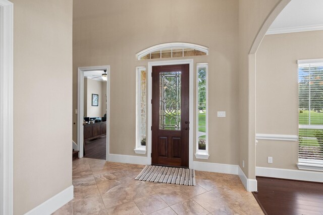29122 Champions Dr, Magnolia, TX 77355 - entryway with plenty of natural light, arched walkways, crown molding, and baseboards
