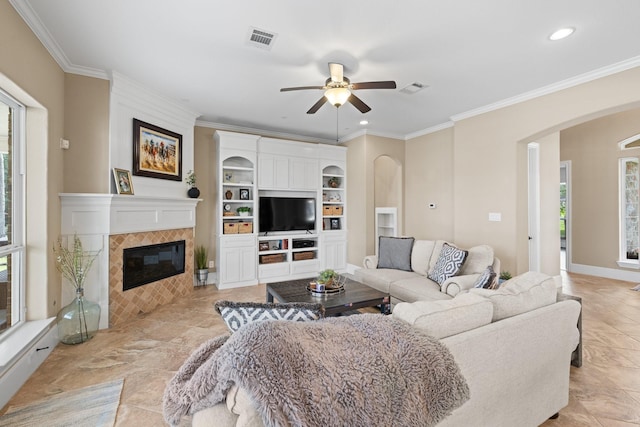 29122 Champions Dr, Magnolia, TX 77355 - living room with arched walkways, healthy amount of natural light, a ceiling fan, recessed lighting, and crown molding