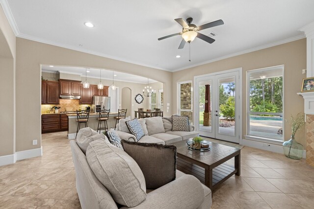 29122 Champions Dr, Magnolia, TX 77355 - living room featuring ornamental molding, a ceiling fan, arched walkways, recessed lighting, and light tile patterned floors