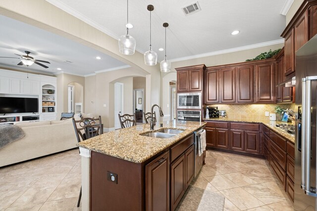 29122 Champions Dr, Magnolia, TX 77355 - kitchen with a sink, arched walkways, stainless steel appliances, ornamental molding, and ceiling fan