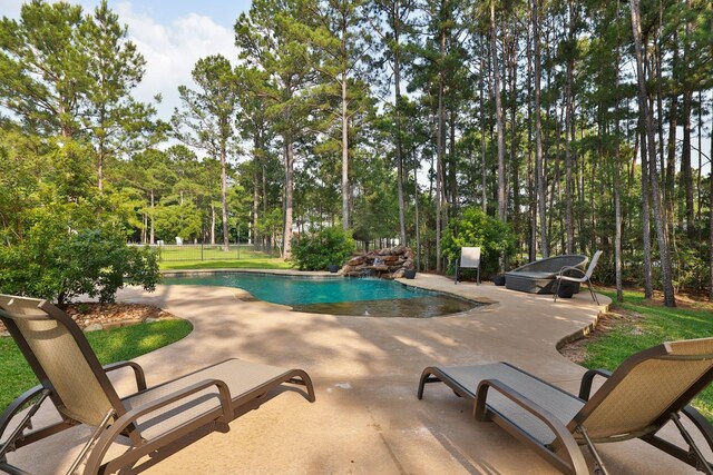 29122 Champions Dr, Magnolia, TX 77355 - outdoor pool featuring a patio and view of wooded area