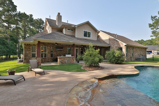 29122 Champions Dr, Magnolia, TX 77355 - back of property featuring a patio area, roof with shingles, brick siding, a chimney, and central air condition unit