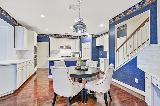 1217 Red Wing Dr, Friendswood, TX 77546 - dining area featuring stairs, dark wood-style floors, baseboards, recessed lighting, and a chandelier