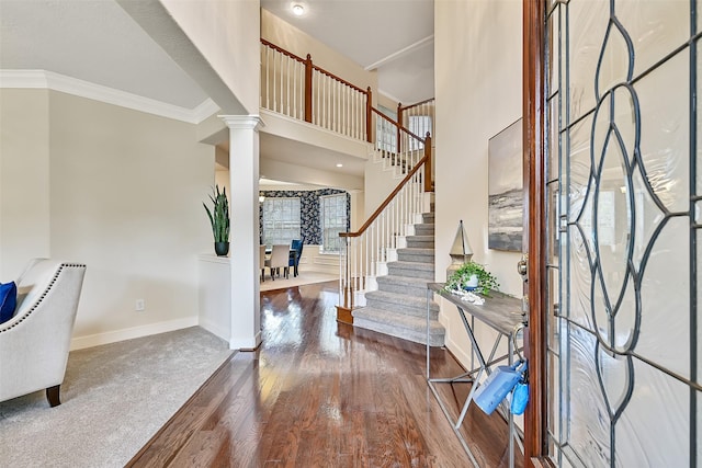 1217 Red Wing Dr, Friendswood, TX 77546 - foyer with ornate columns, wood finished floors, stairs, baseboards, and ornamental molding