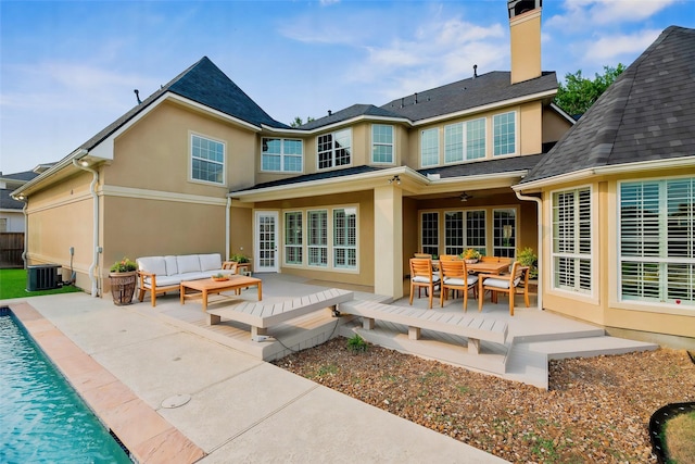 19907 Westside Forest Dr, Houston, TX 77094 - rear view of house featuring outdoor lounge area, stucco siding, cooling unit, a ceiling fan, and a patio