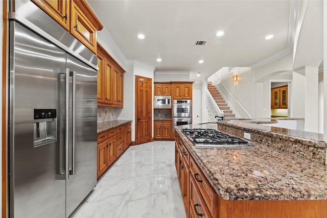 19907 Westside Forest Dr, Houston, TX 77094 - kitchen featuring built in appliances, ornamental molding, brown cabinetry, light marble finish flooring, and stone counters