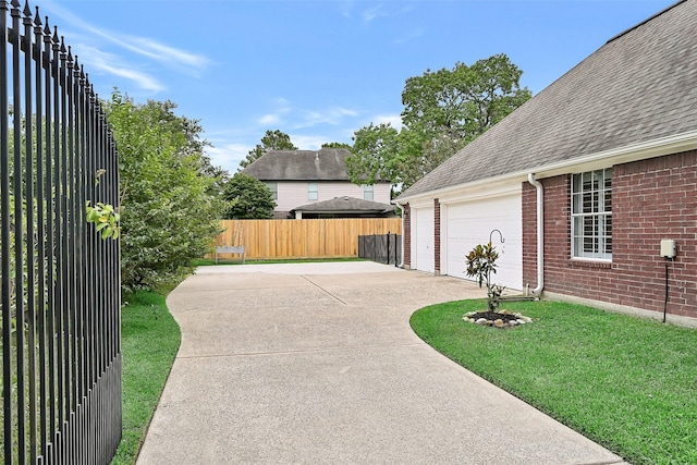 1405 Blueberry Ln, Friendswood, TX 77546 - view of patio with a garage and driveway